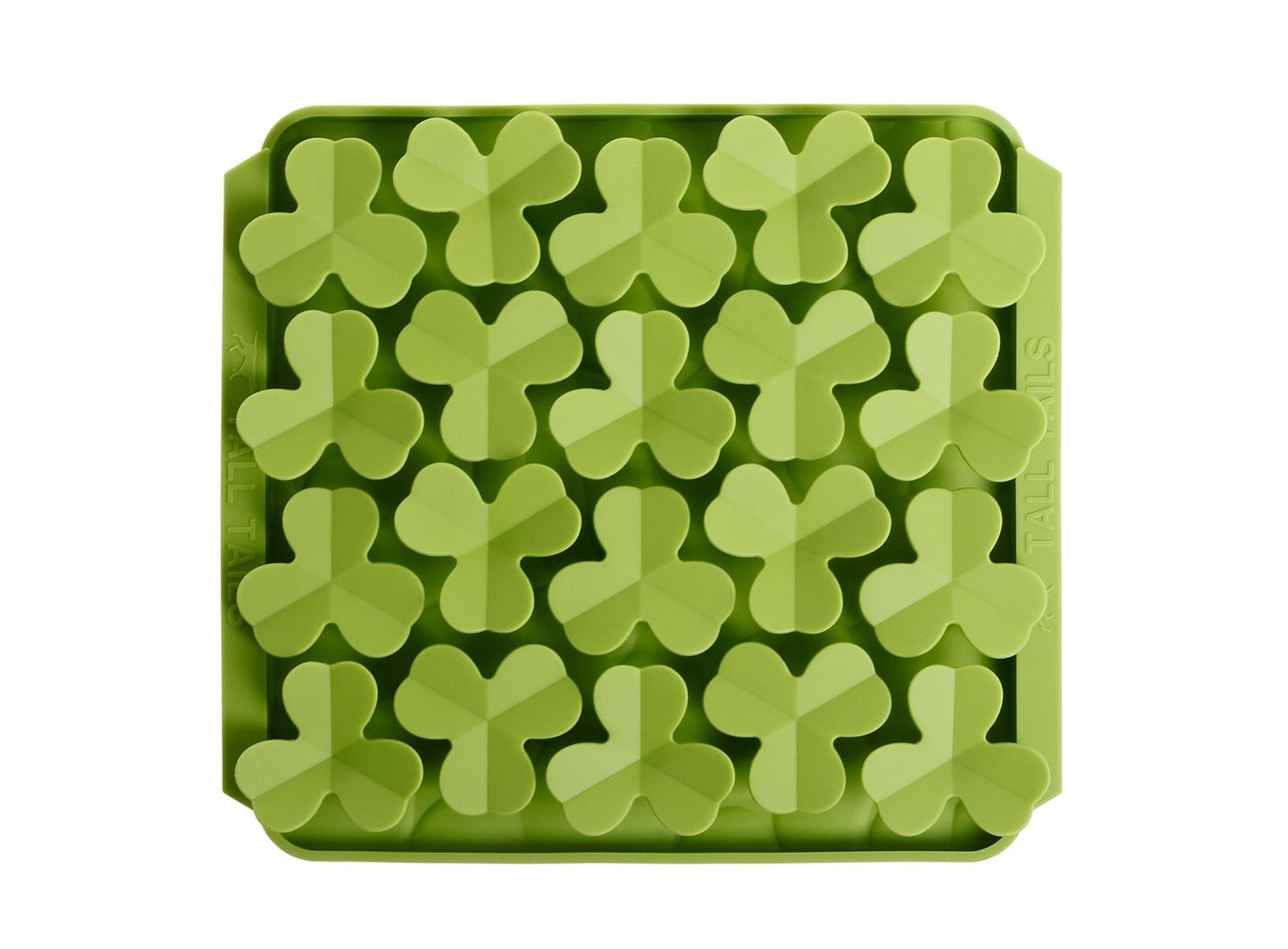 top view of a green silicone lick mat with silicone clovers on top for dogs