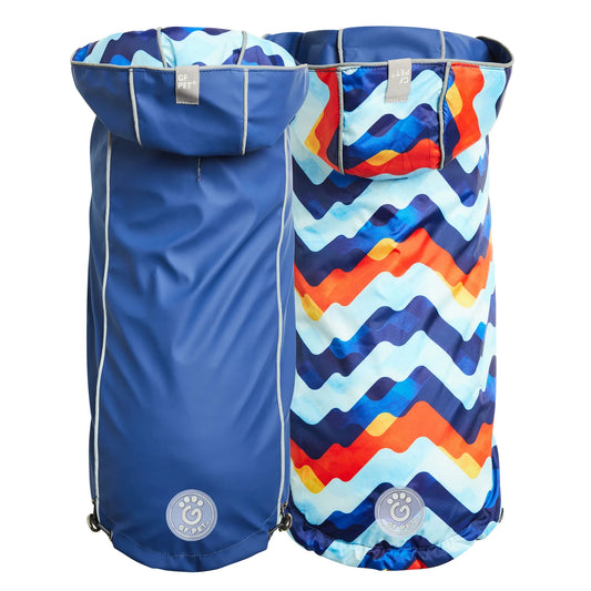 two back views of a navy blue reversible dog raincoat with a colorful zigzag pattern on the other side