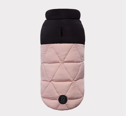 Quilted dog coat with black top and pink body on a light gray background