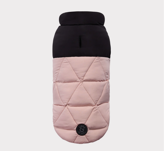Quilted dog coat with black top and pink body on a light gray background