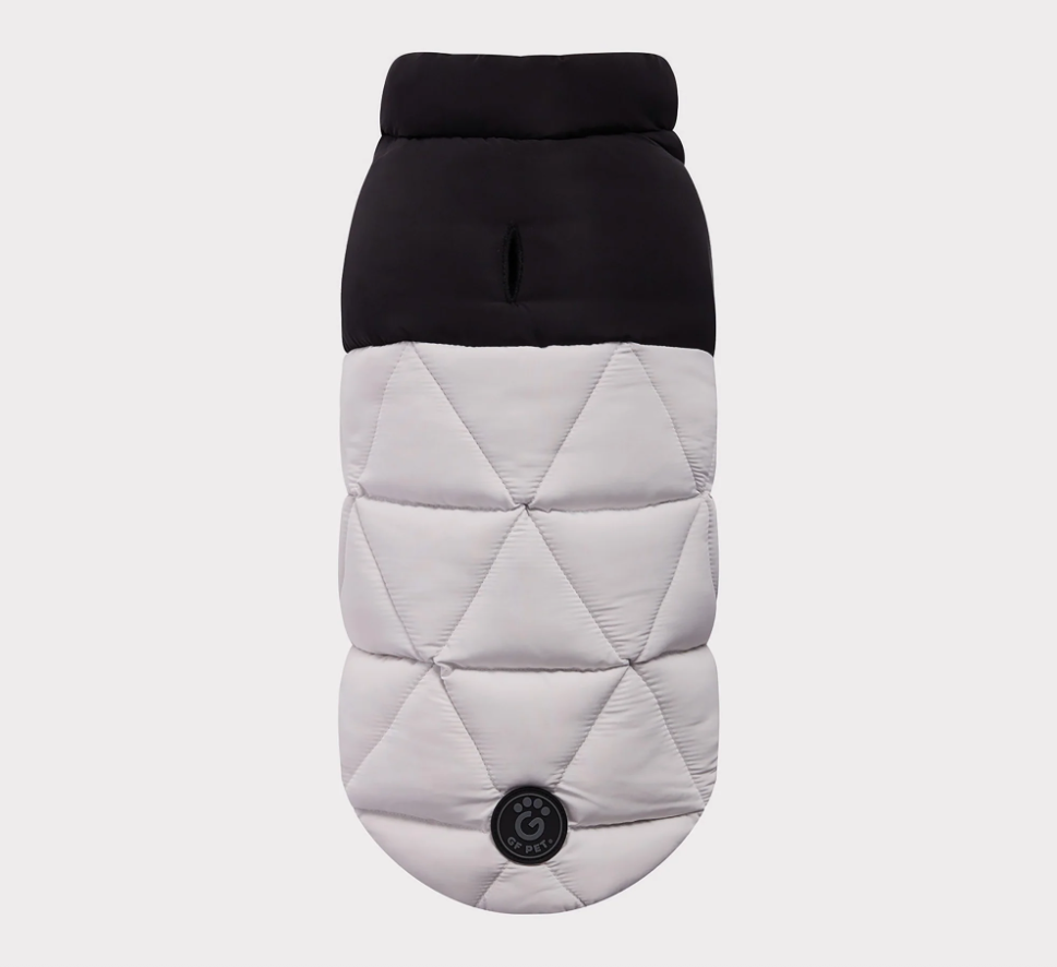 Quilted dog coat with black top and gray diamond pattern on a light gray background