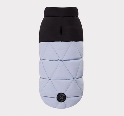 Quilted dog coat with black top and light gray bottom on a white background