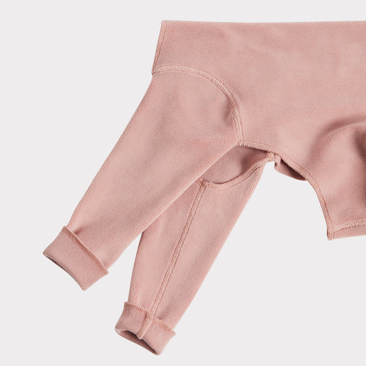 close up of a blush pink fleece dog onesie