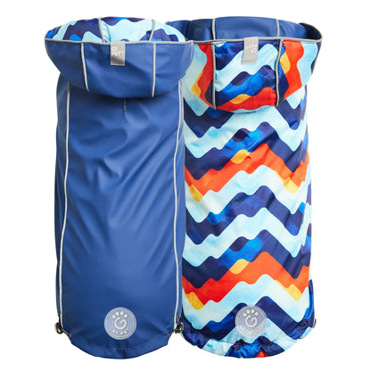 two back views of a navy blue reversible dog raincoat with a colorful zigzag pattern on the other side