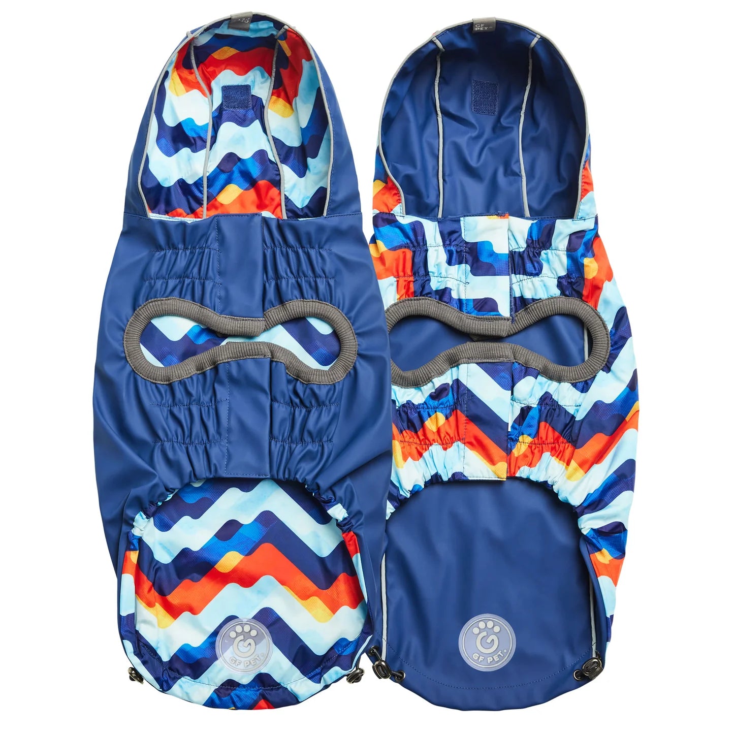 Underside view of a navy blue reversible dog raincoat with a colorful zigzag pattern on one side
