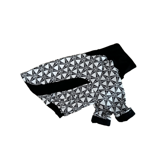 side view of a Black and white geometric print dog coat on a white background