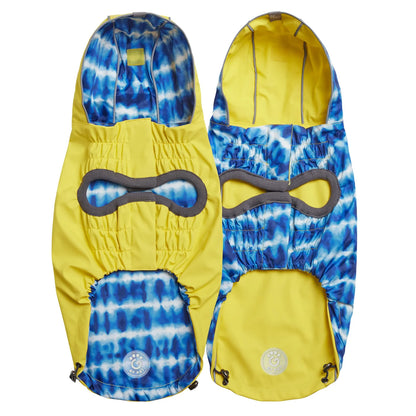 Underside view of a yellow reversible dog raincoat with a blue and white tie dye  pattern on one side